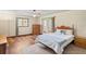 Large bedroom with a ceiling fan, windows, wood floors, and exterior access at 7169 Spruce Dr, Weeki Wachee, FL 34607