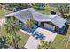 Charming single-Gathering home features an attached garage, driveway, and palm trees in the front yard at 7169 Spruce Dr, Weeki Wachee, FL 34607