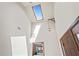 Bright foyer with a skylight, showcasing the home's unique architecture and a view to the main bedroom at 7169 Spruce Dr, Weeki Wachee, FL 34607