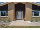 Close up of front entry with brick facade and decorative plants at 7169 Spruce Dr, Weeki Wachee, FL 34607
