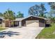 Exterior view featuring the garage, driveway, and front exterior at 7169 Spruce Dr, Weeki Wachee, FL 34607