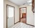 The tiled hallway leads to a bedroom with a wooden dresser and a door to the exterior at 7169 Spruce Dr, Weeki Wachee, FL 34607