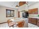 Kitchen showcasing range-top island with seating, a window view, and sleek appliances at 7169 Spruce Dr, Weeki Wachee, FL 34607
