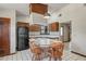 Kitchen featuring a range top island, dark cabinetry, and a black refrigerator at 7169 Spruce Dr, Weeki Wachee, FL 34607