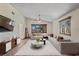Spacious living room with vaulted ceiling, oversized window, and modern furnishings at 7169 Spruce Dr, Weeki Wachee, FL 34607