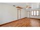 Bright living room features beautiful wood flooring, ceiling fan, and natural light at 7169 Spruce Dr, Weeki Wachee, FL 34607