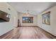 Spacious living room featuring wood-look flooring, neutral walls, and plenty of natural light from windows at 7169 Spruce Dr, Weeki Wachee, FL 34607