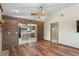 Open concept living room with wood paneled feature wall, hardwood floors, open to the kitchen at 7169 Spruce Dr, Weeki Wachee, FL 34607