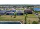 Aerial view of the home showcasing the large backyard with a beautiful lake view at 7215 Wash Island Dr, Sun City Center, FL 33573