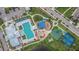 Aerial view of community amenities featuring a pool, playground, basketball court, and parking at 7215 Wash Island Dr, Sun City Center, FL 33573