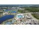 Aerial view of community amenities, including the pool, playground, and sports courts near multiple lakes at 7215 Wash Island Dr, Sun City Center, FL 33573