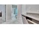 View of a bathroom featuring a granite vanity, tiled floors, and combination tub and shower at 7215 Wash Island Dr, Sun City Center, FL 33573