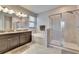 This bathroom features double sinks, a bathtub, and glass-enclosed shower at 7215 Wash Island Dr, Sun City Center, FL 33573