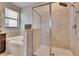 This bathroom features an enclosed glass shower, a tub, and tile flooring at 7215 Wash Island Dr, Sun City Center, FL 33573
