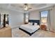This main bedroom is lit with tray ceilings, natural light and neutral paint tones at 7215 Wash Island Dr, Sun City Center, FL 33573