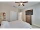 This bedroom features a ceiling fan, TV atop the dresser, and closet for plenty of storage at 7215 Wash Island Dr, Sun City Center, FL 33573