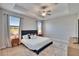 This staged main bedroom boasts ample natural light, tray ceilings, and comfortable carpet at 7215 Wash Island Dr, Sun City Center, FL 33573