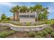 Beautiful Cypress Mill community sign with elegant landscaping, palm trees, and stone accents at 7215 Wash Island Dr, Sun City Center, FL 33573