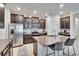 Open concept kitchen with dark wood cabinets, stainless steel appliances, and granite countertops at 7215 Wash Island Dr, Sun City Center, FL 33573
