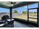 Relaxing screened lanai with ceiling fan overlooking the fenced-in backyard and view of the community landscape at 7215 Wash Island Dr, Sun City Center, FL 33573