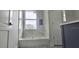 Bathroom featuring a sleek bathtub, tiled walls, and modern fixtures near a door at 745 31St N Ave, St Petersburg, FL 33704