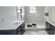 Elegant bathroom with double vanities, modern fixtures, and a walk-in shower featuring marble at 745 31St N Ave, St Petersburg, FL 33704