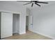 Bedroom featuring sliding closet doors, wood floors, and a ceiling fan at 745 31St N Ave, St Petersburg, FL 33704