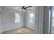 Bedroom with hardwood floors, white trim, ceiling fan, and natural light from two windows at 745 31St N Ave, St Petersburg, FL 33704