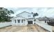 Charming two-story home with a covered front porch and an attached garage at 745 31St N Ave, St Petersburg, FL 33704