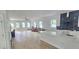Open-concept kitchen with hardwood floors, white cabinets, a large island, and plenty of natural light at 745 31St N Ave, St Petersburg, FL 33704