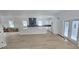 Bright, open-concept kitchen featuring white cabinets, a large island, and stainless steel appliances at 745 31St N Ave, St Petersburg, FL 33704