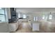 Modern kitchen with white cabinetry, stainless steel appliances, and a spacious center island at 745 31St N Ave, St Petersburg, FL 33704