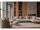 Elegant living room with a fireplace, built-in shelving, comfortable seating, and an area rug on hardwood floors at 77 Avonwood, Tampa, FL 33625