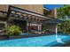 Stunning backyard pool area with lounge chairs, modern architecture, and lush greenery creating a luxurious outdoor space at 77 Avonwood, Tampa, FL 33625