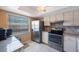 Well-lit kitchen featuring stainless steel appliances and white cabinetry at 7700 92Nd St # 207, Seminole, FL 33777