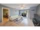 Bright living room with a sliding glass door to balcony, ceiling fan, and comfortable seating at 7700 92Nd St # 207, Seminole, FL 33777