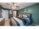 The main bedroom features an accent wall, ceiling fan, a double door entrance, and an ensuite bathroom at 7700 92Nd St # 207, Seminole, FL 33777