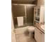 Cozy bathroom featuring a shower with glass doors, single sink vanity, and storage cabinet at 7701 Starkey Rd # 602, Seminole, FL 33777