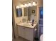 Bathroom featuring a single sink vanity, large mirror, and built-in shelving unit at 7701 Starkey Rd # 602, Seminole, FL 33777