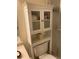 Well-organized bathroom featuring a cabinet above the toilet and a glass shower door at 7701 Starkey Rd # 602, Seminole, FL 33777