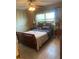Cozy bedroom featuring a ceiling fan, window with blinds, and a comfortable bed with side tables at 7701 Starkey Rd # 602, Seminole, FL 33777