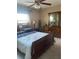Bedroom featuring a bed, ceiling fan, dresser with mirror, and warm lighting at 7701 Starkey Rd # 602, Seminole, FL 33777