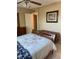 Comfortable bedroom with a ceiling fan, closet, and a bed featuring patterned blankets and pillow at 7701 Starkey Rd # 602, Seminole, FL 33777