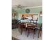 Dining room with a view into the kitchen, featuring a large wooden table, chairs, and decorative accents at 7701 Starkey Rd # 602, Seminole, FL 33777