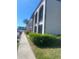 Exterior view featuring the building's facade, and lush greenery in a landscaped setting at 7701 Starkey Rd # 602, Seminole, FL 33777