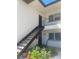 Charming condo with a staircase leading to upper-level units and vibrant landscaping at 7701 Starkey Rd # 602, Seminole, FL 33777