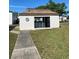 Exterior image of the community laundry building, with a walkway and landscaped lawn at 7701 Starkey Rd # 602, Seminole, FL 33777