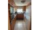 Functional kitchen with wood cabinetry, granite countertops, and modern appliances at 7701 Starkey Rd # 602, Seminole, FL 33777