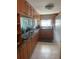 Functional kitchen with wood cabinetry, granite countertops, and modern appliances at 7701 Starkey Rd # 602, Seminole, FL 33777