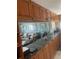 Inviting living room with a comfortable couch visible through the pass-through kitchen counter and cabinets at 7701 Starkey Rd # 602, Seminole, FL 33777